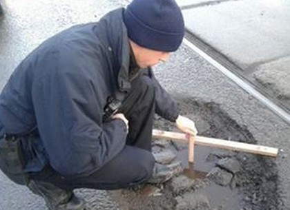 Харьковские копы измеряют и берут на учет все ямы и выбоины на дорогах (ФОТО)